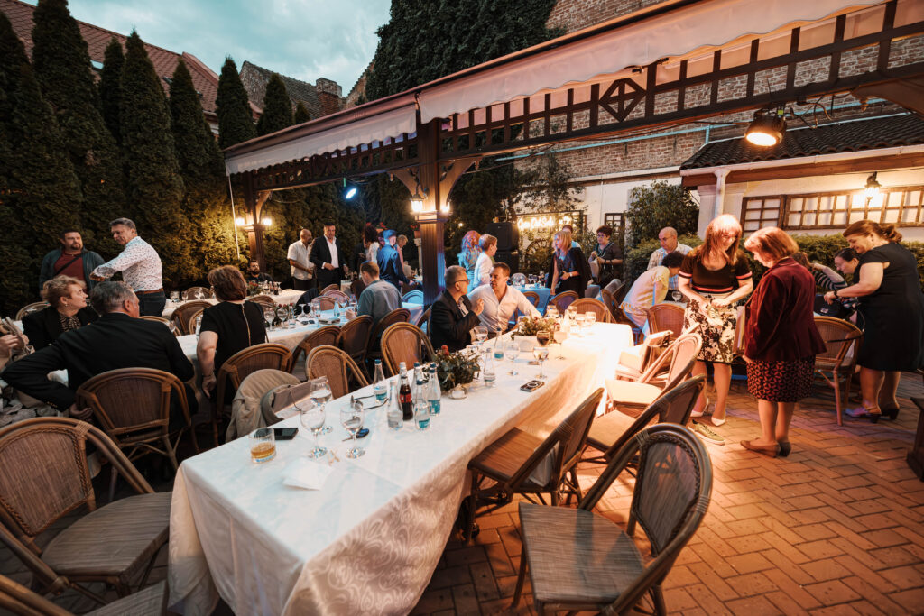 Garden party with guests at festive meals.