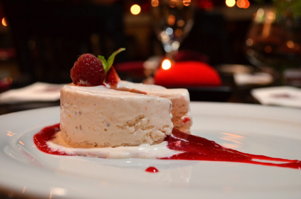 Frozen dessert with raspberries and red sauce