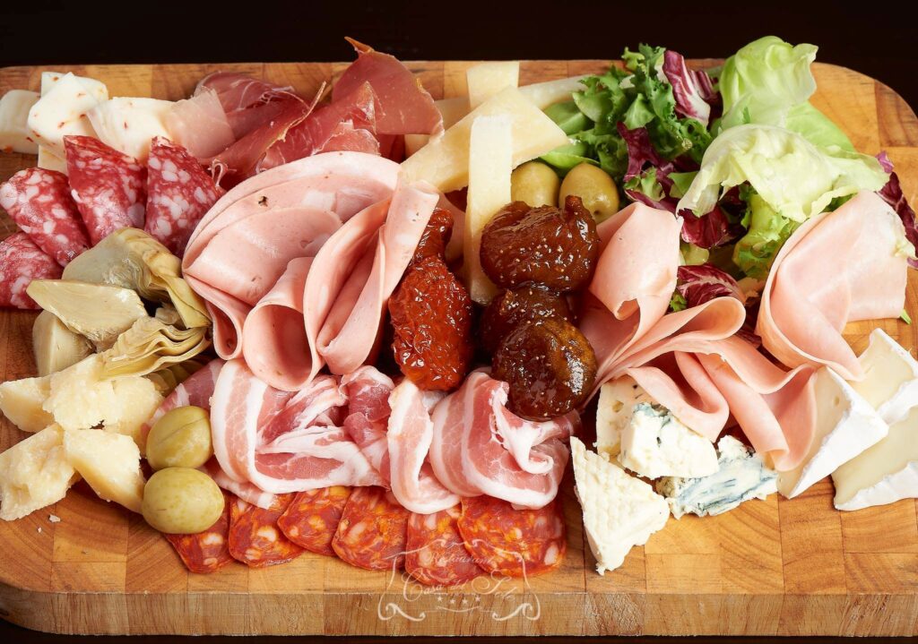 Charcuterie platter with cheese and fresh vegetables
