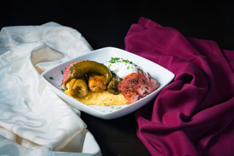 Picture with Cabbage dumplings in cabbage leaves with mămăliguță and sour cream